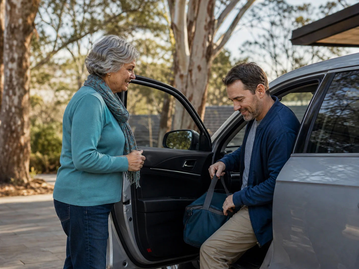 Volunteer helping a man into a car for treatment transport